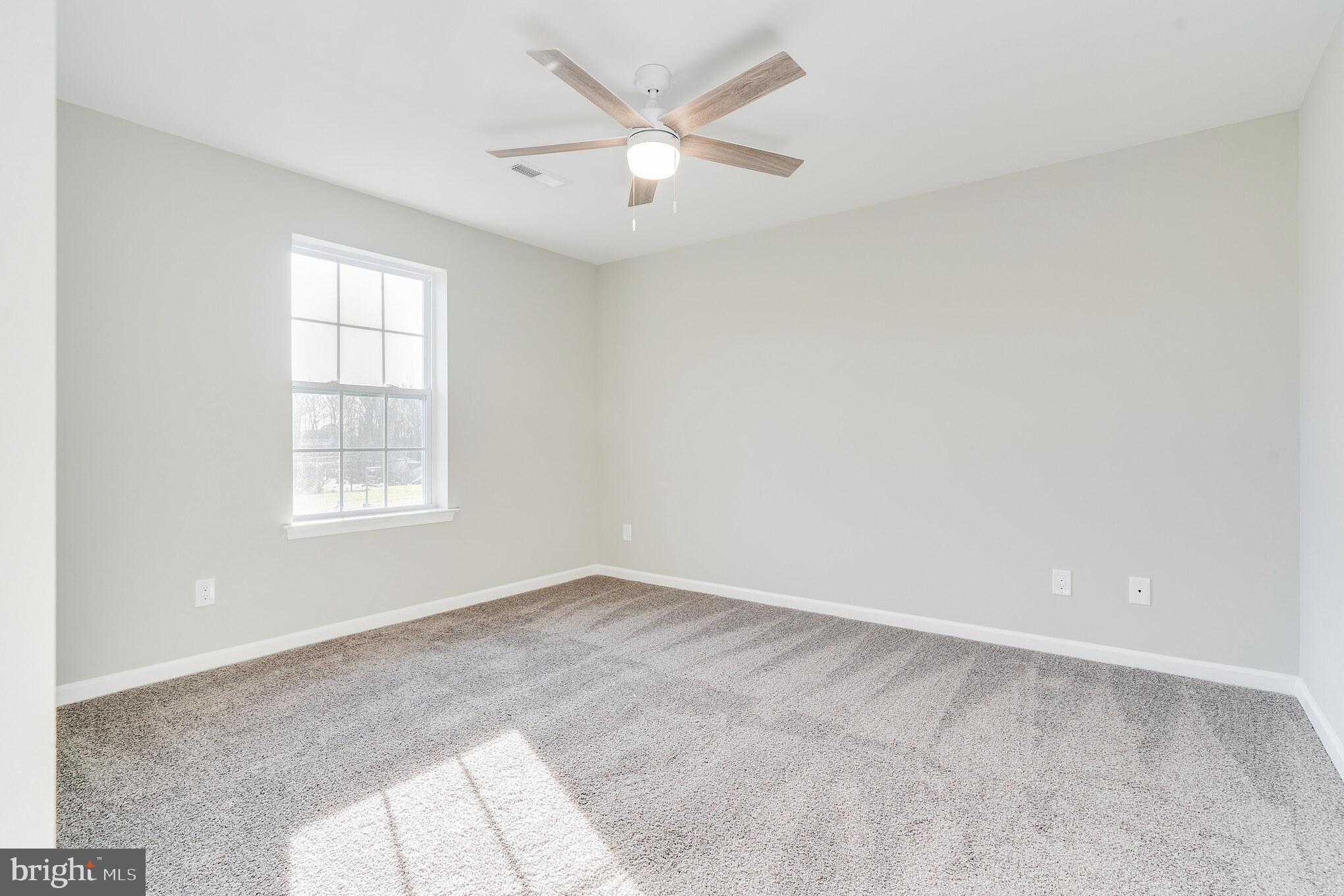 1021 West Maple Avenue Langhorne, PA 19047 - Photo 16 of 37 an empty room with a window and a ceiling fan