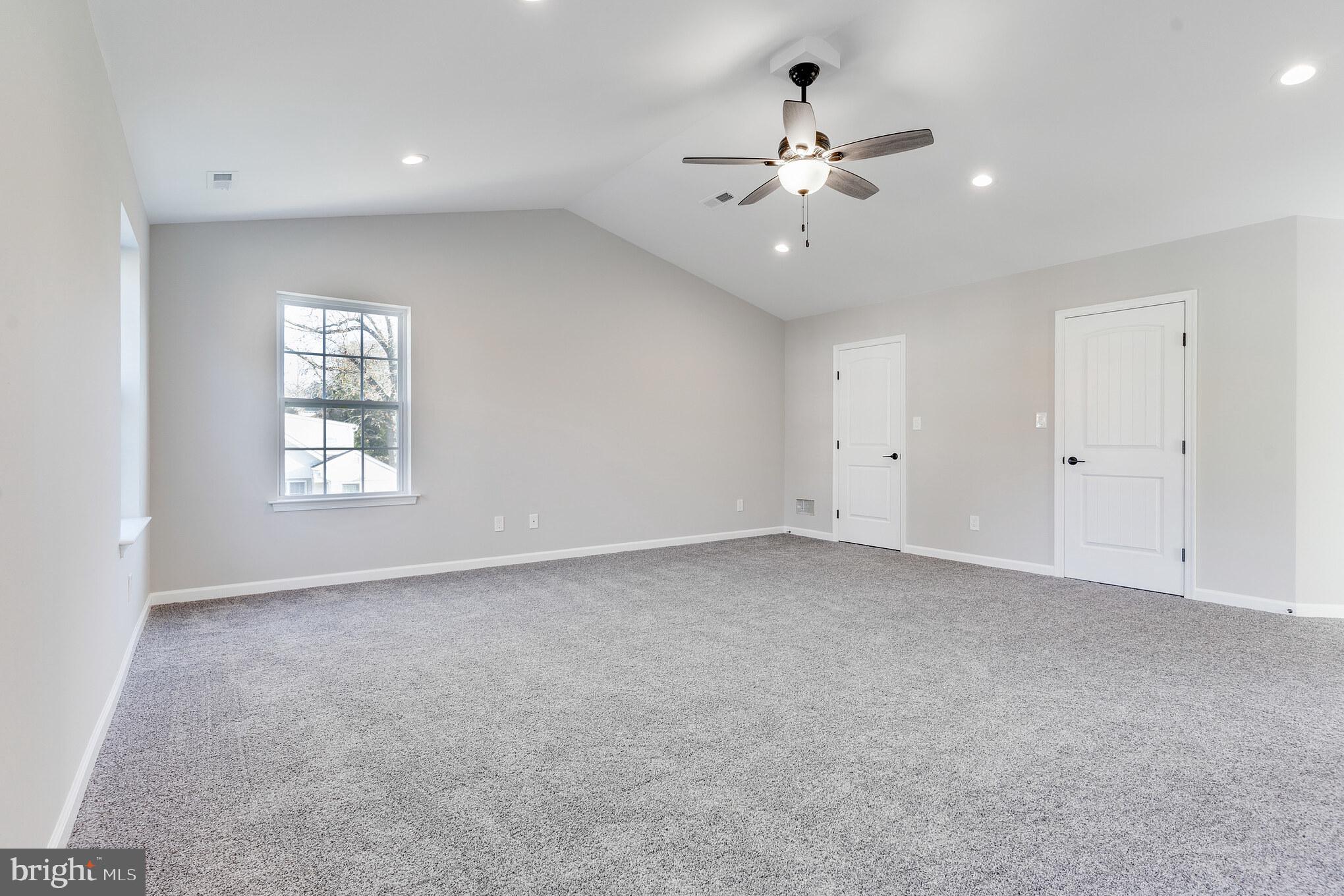 1021 West Maple Avenue Langhorne, PA 19047 - Photo 20 of 37 an empty room with chandelier fan and windows