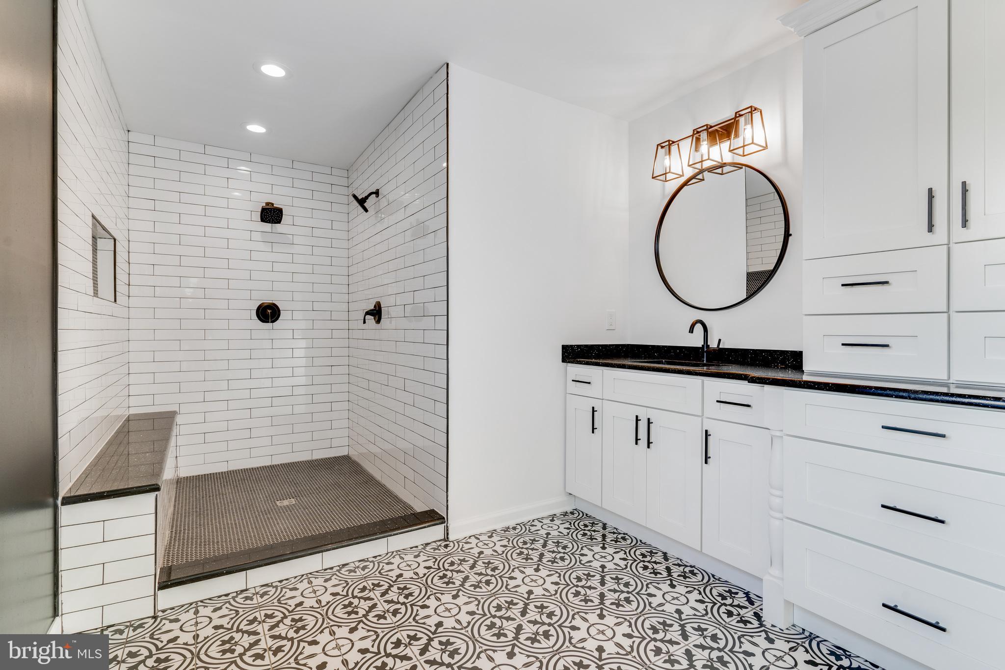 1021 West Maple Avenue Langhorne, PA 19047 - Photo 21 of 37 a bathroom with a granite countertop sink a mirror and shower