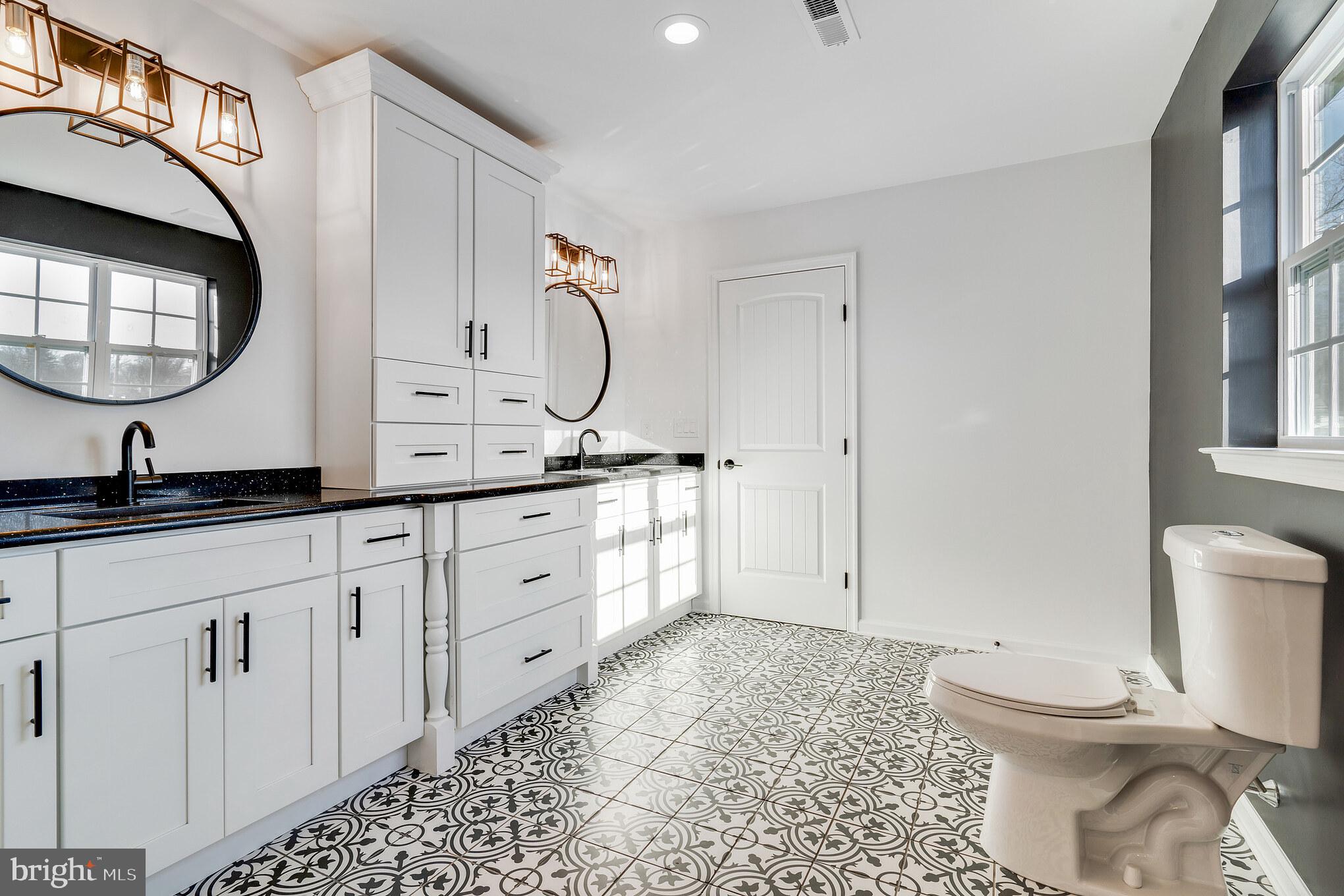 1021 West Maple Avenue Langhorne, PA 19047 - Photo 22 of 37 a spacious bathroom with a toilet a sink and a mirror
