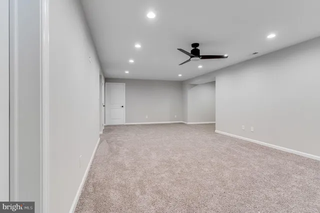 wooden floor in an empty room with a ceiling fan