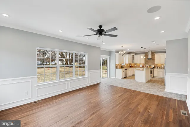 a view of a kitchen with wooden floor and a kitchen