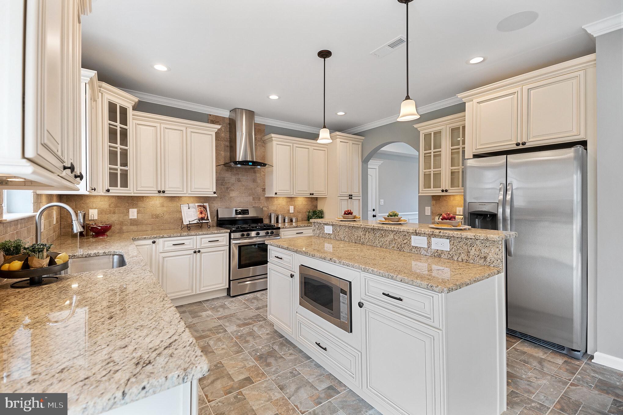 1021 West Maple Avenue Langhorne, PA 19047 - Photo 34 of 37 a kitchen with stainless steel appliances granite countertop a sink a stove a refrigerator and cabinets