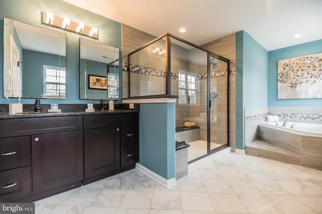 a spacious bathroom with a sink mirror and a bath tub