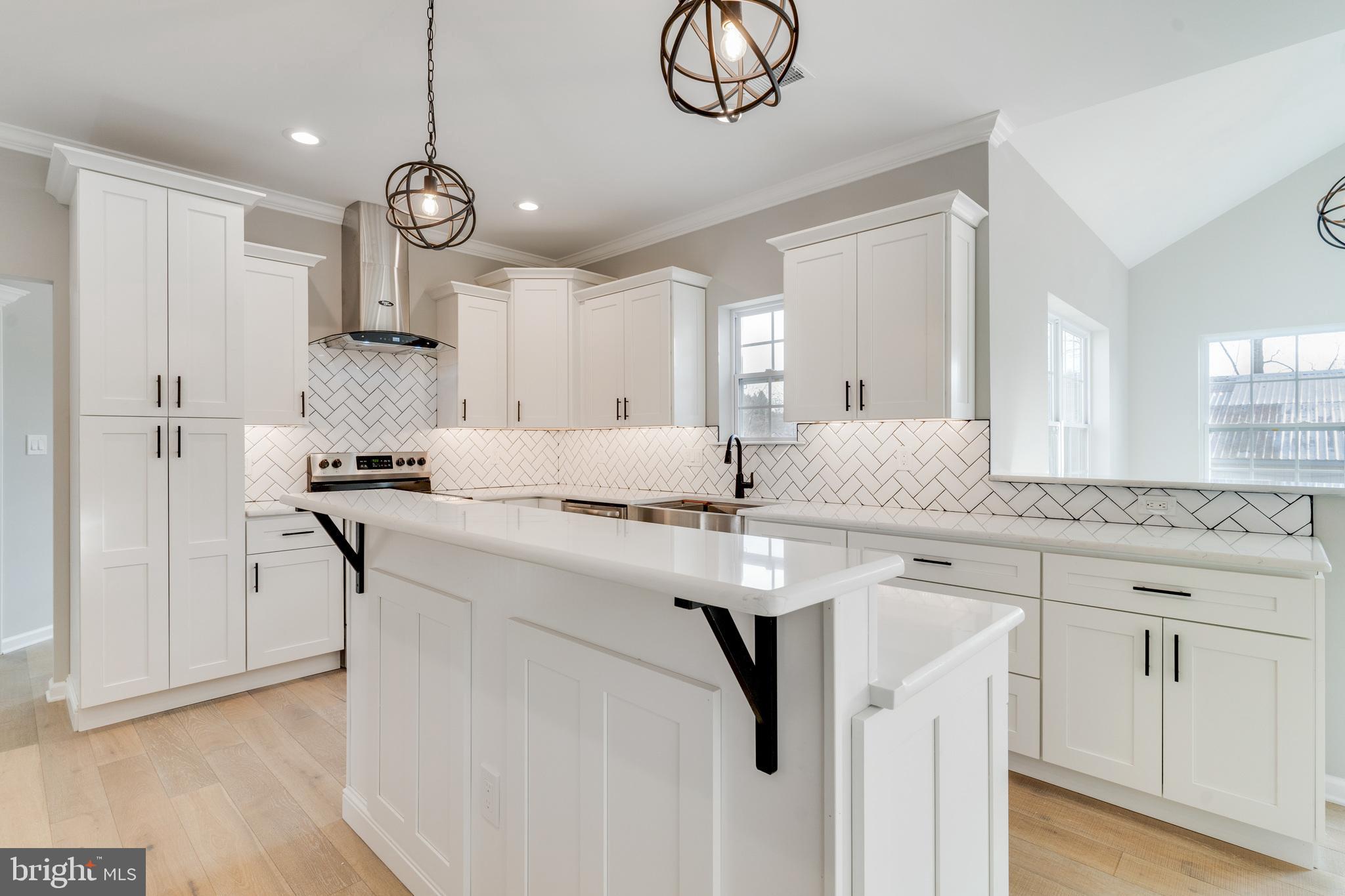 1021 West Maple Avenue Langhorne, PA 19047 - Photo 4 of 37 a kitchen with center island cabinets and stainless steel appliances
