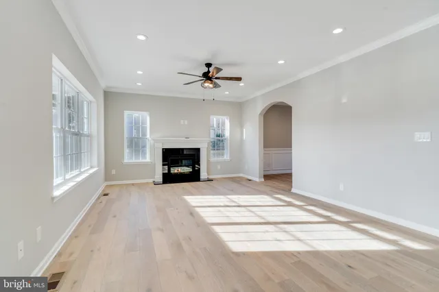 a view of an empty room with a fireplace and a window
