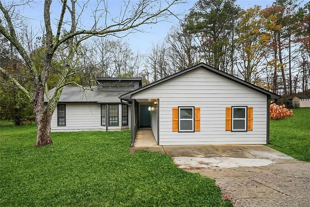 a front view of a house with a garden