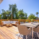 a view of a patio with dining table and chairs with wooden floor