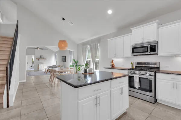 a kitchen with a sink stove and microwave