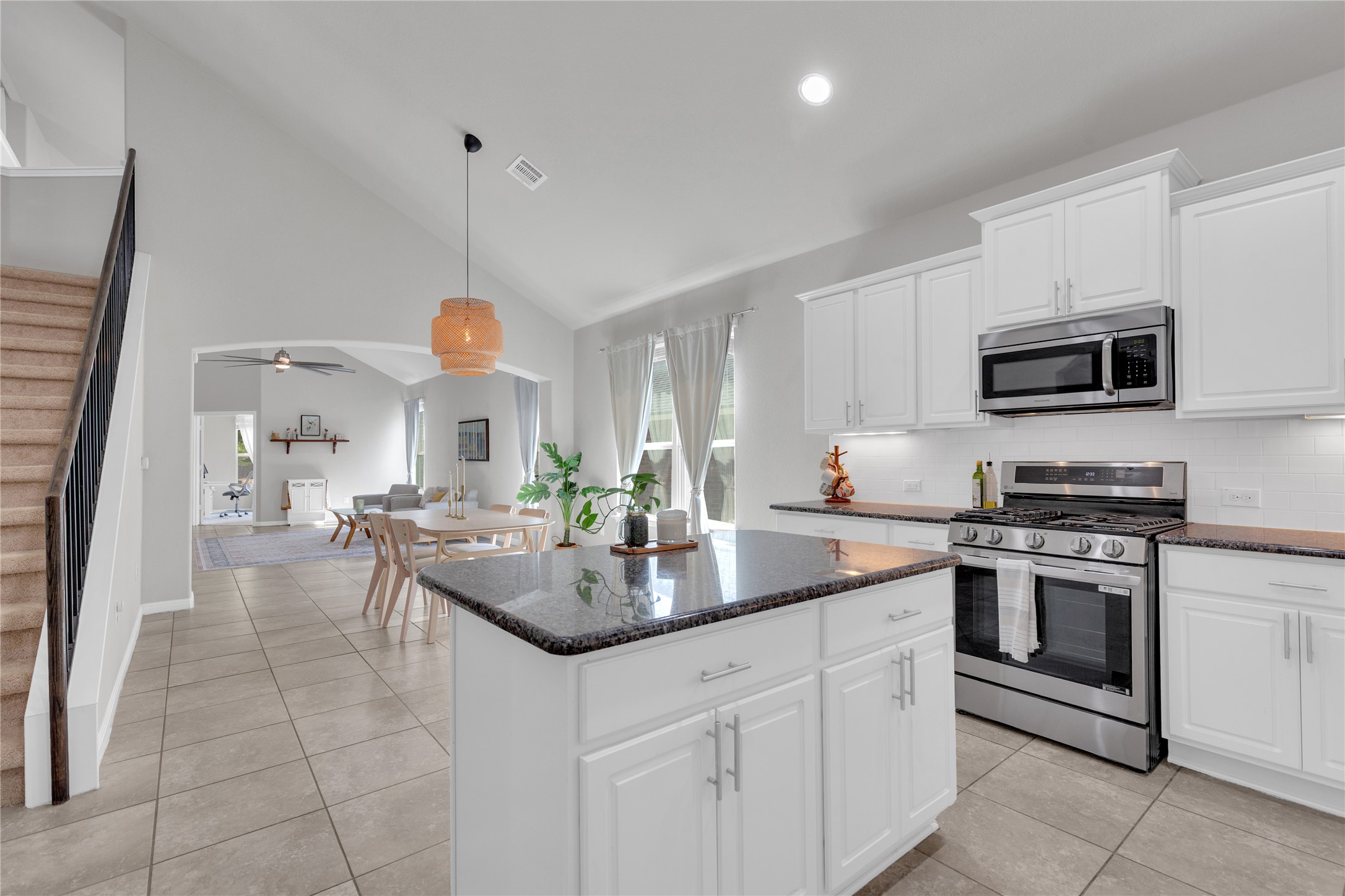 721 Schefer Street Leander, TX 78641 - Photo 14 of 38 a kitchen with a sink stove and microwave