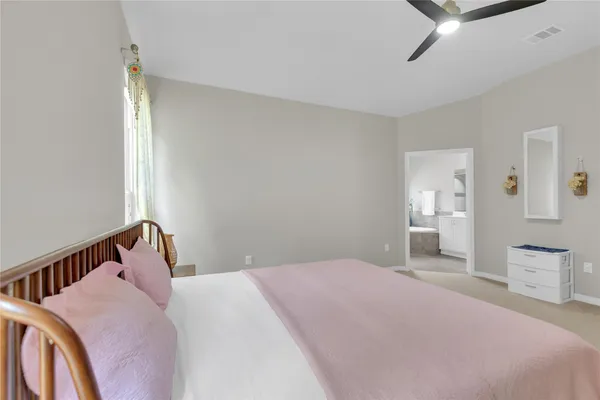 a bedroom with a bed and a large mirror