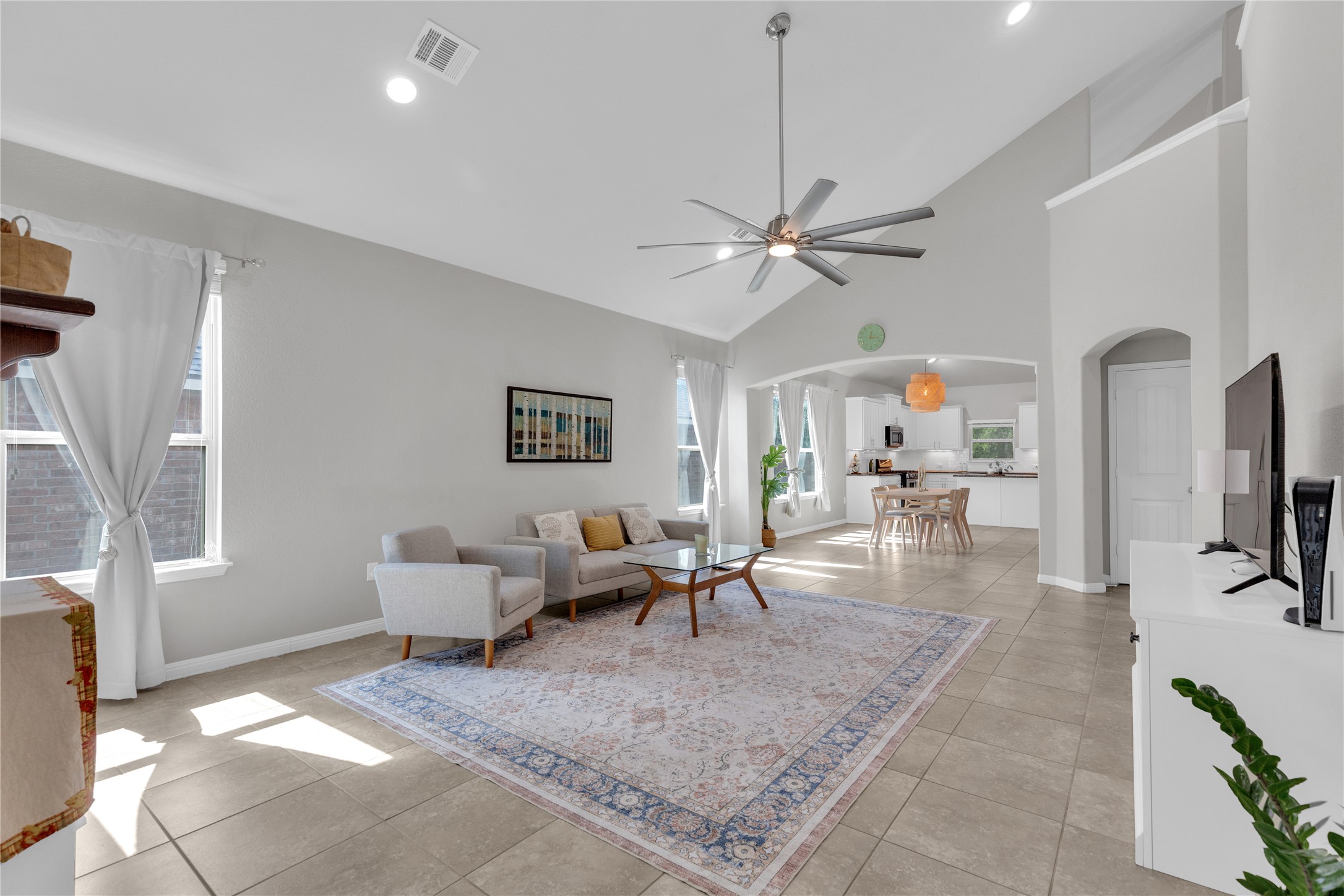 721 Schefer Street Leander, TX 78641 - Photo 2 of 38 a living room with furniture a flat screen tv and a table