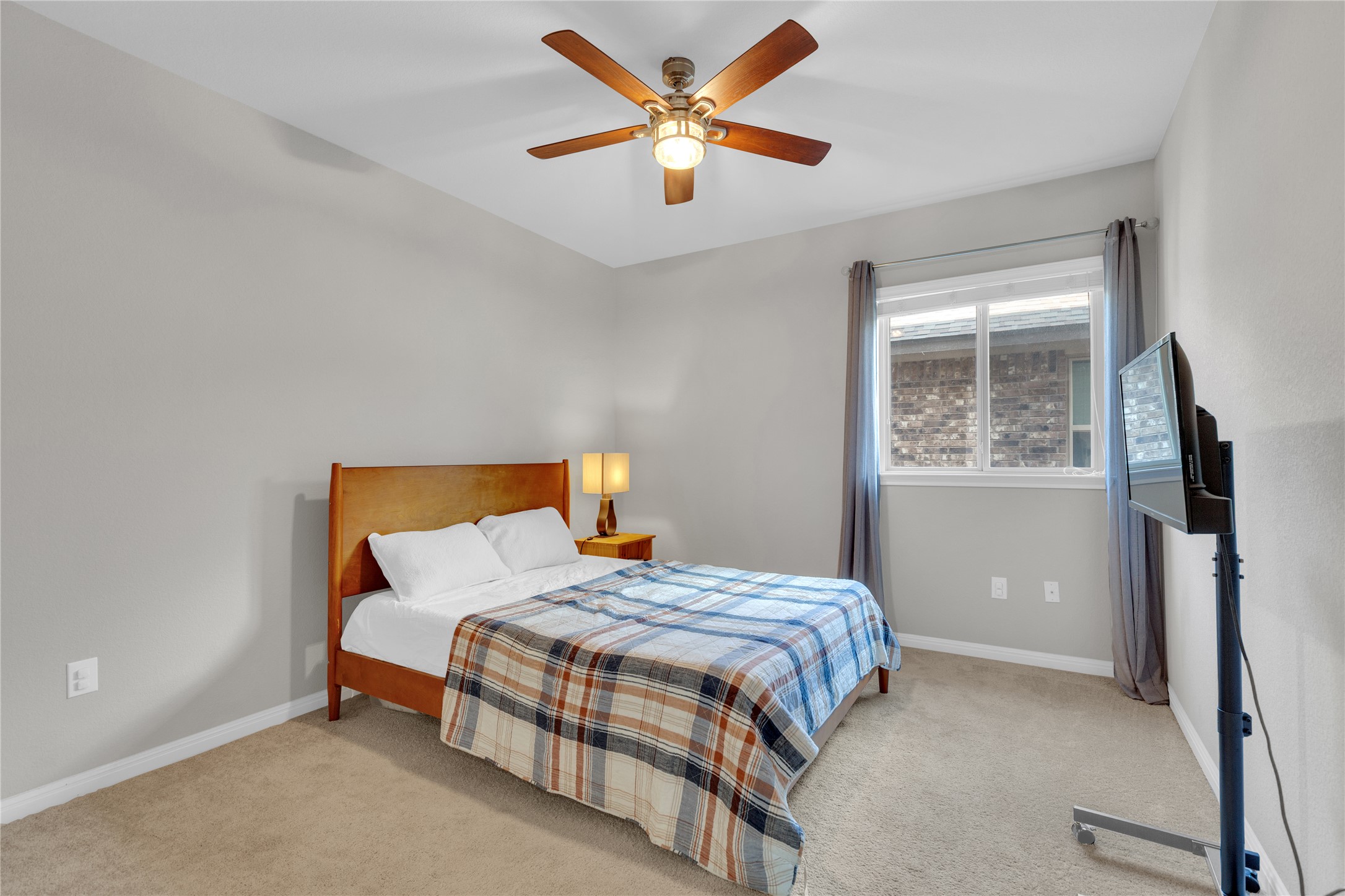 721 Schefer Street Leander, TX 78641 - Photo 23 of 38 a bedroom with a bed and a ceiling fan