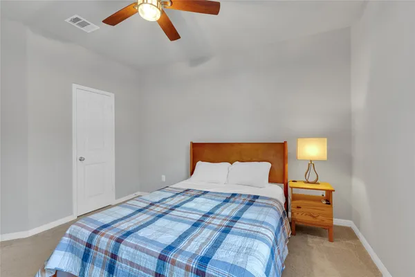 a bedroom with a bed and a lamp