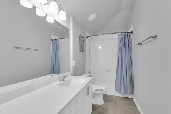 a bathroom with a double vanity sink mirror and toilet