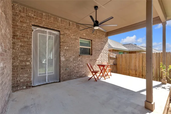 a view of a patio with a table and chairs