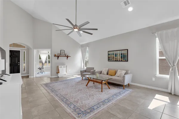 a living room with furniture and a chandelier