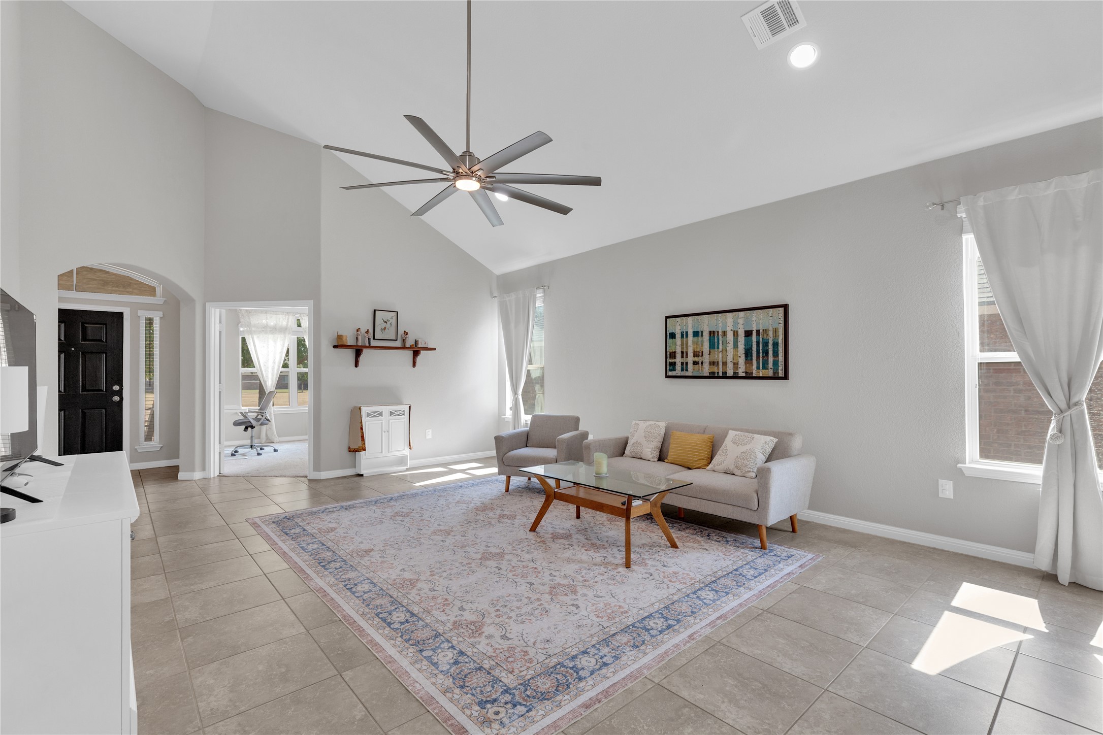 721 Schefer Street Leander, TX 78641 - Photo 6 of 38 a living room with furniture and a chandelier