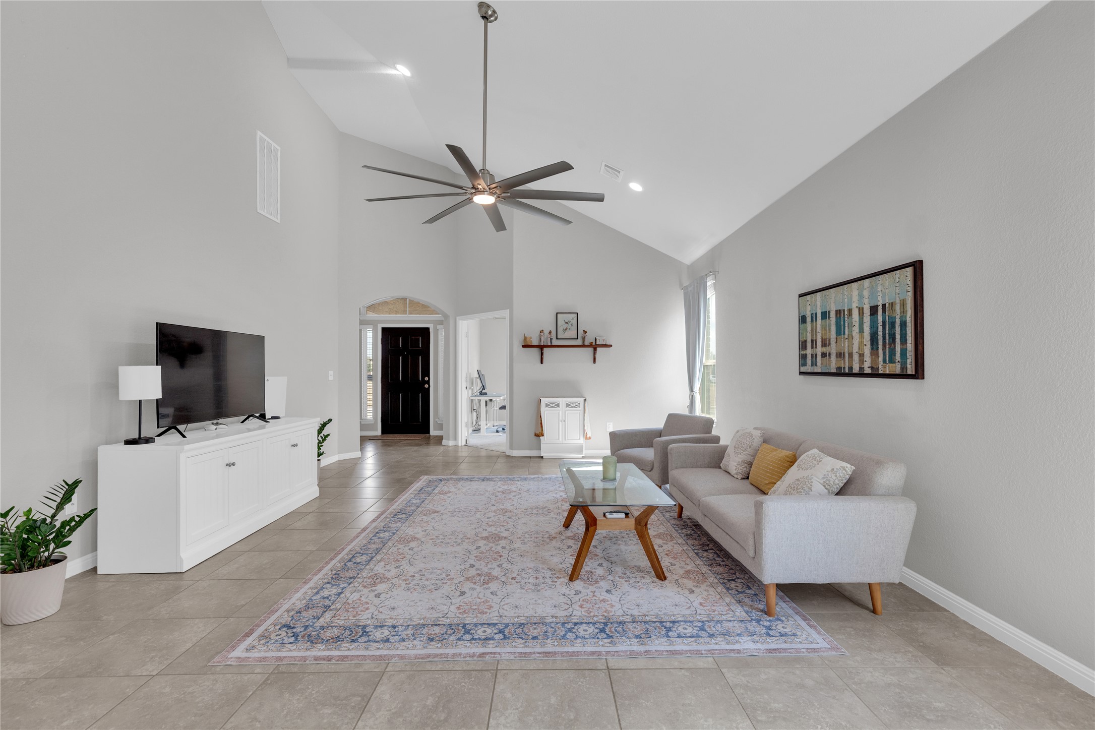 721 Schefer Street Leander, TX 78641 - Photo 7 of 38 a living room with furniture and a flat screen tv