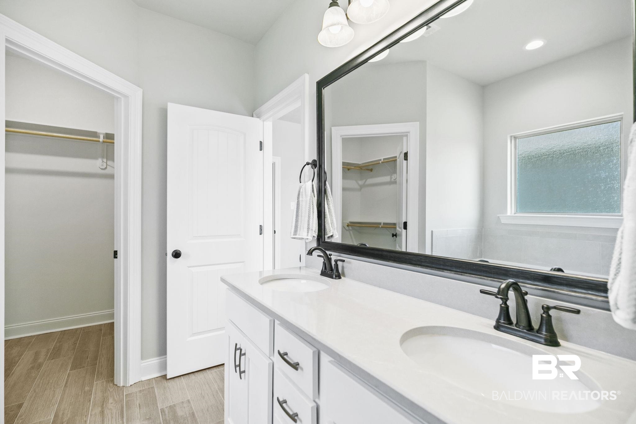 10140 Chipper Lane Foley, AL 36535 - Photo 31 of 72 Bathroom featuring hardwood / wood-style floors and vanity