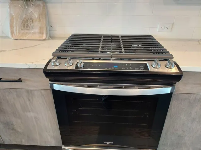 a stove top oven sitting inside of a kitchen