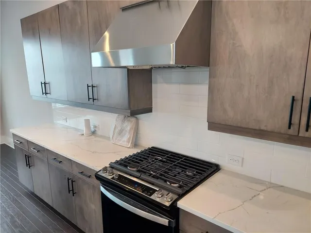 a kitchen with a stove and a sink