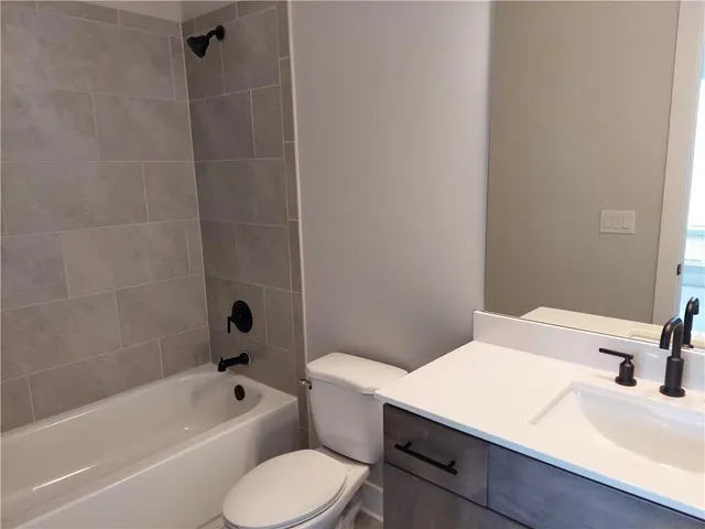 a bathroom with a sink a toilet and a bathtub
