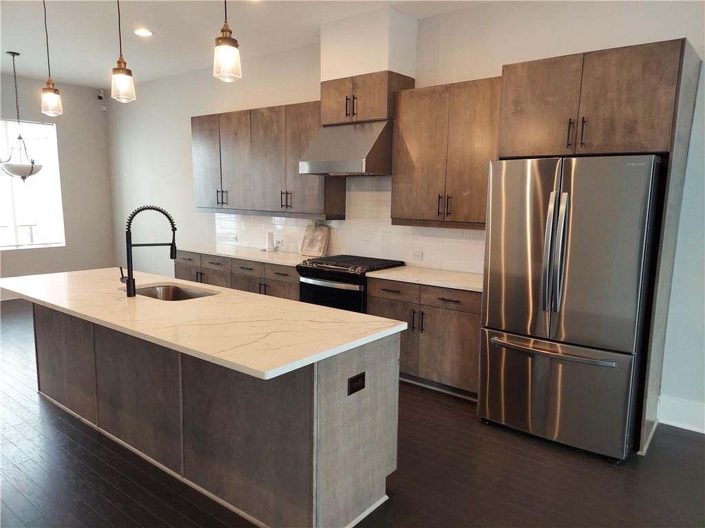 314 Fair Street Southwest Atlanta, GA 30313 - Photo 2 of 22 a kitchen with kitchen island a counter top space cabinets and stainless steel appliances