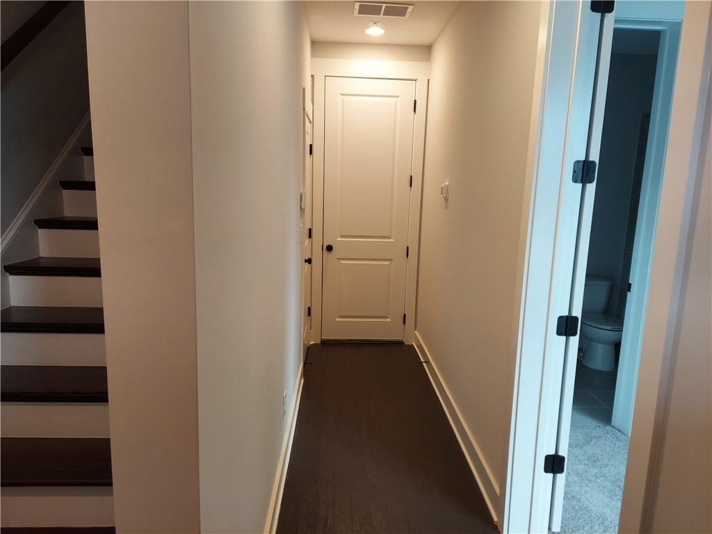 314 Fair Street Southwest Atlanta, GA 30313 - Photo 6 of 22 a view of a hallway with wooden floor and staircase