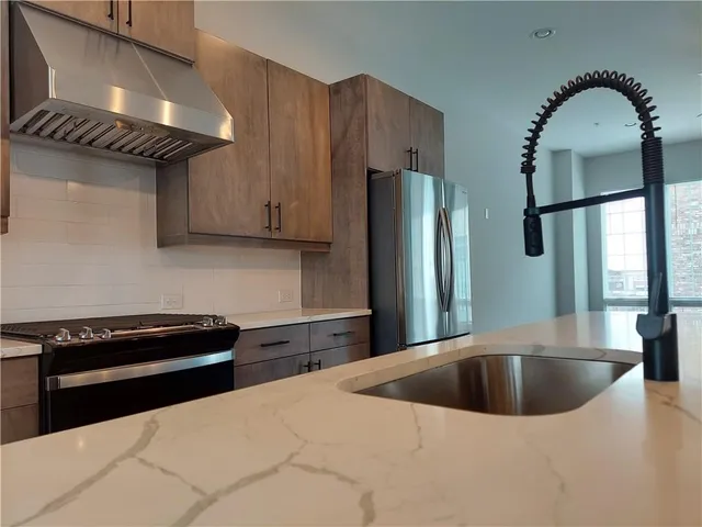 a kitchen with a refrigerator and a sink