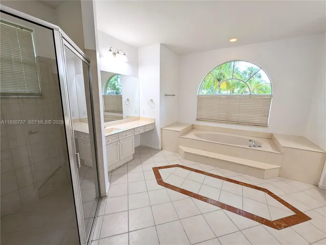 a bathroom with a tub and shower