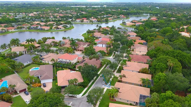 an aerial view of lake and residential houses with outdoor space