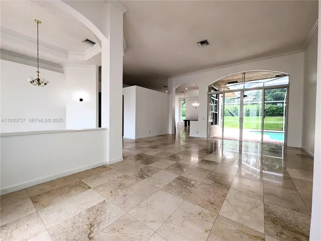 a view of a room with a ceiling fan and window