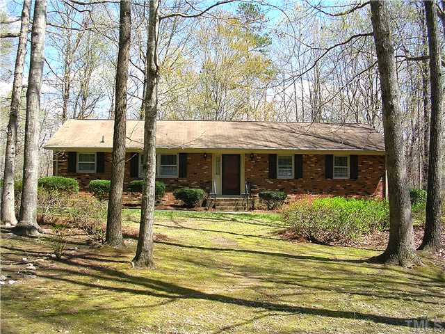 5814 Geoffrey Road Durham, NC 27712 - Photo 1 of 22 a front view of a house with garden