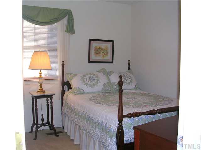 5814 Geoffrey Road Durham, NC 27712 - Photo 14 of 22 a bedroom with a bed and a painting on the wall