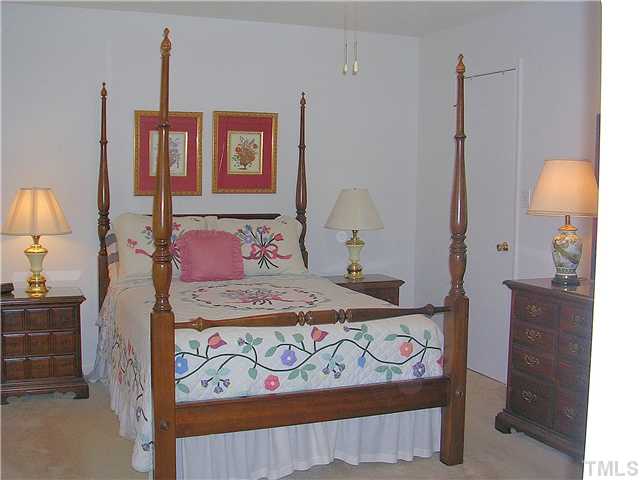 5814 Geoffrey Road Durham, NC 27712 - Photo 15 of 22 a bedroom with a bed next to a window and desk