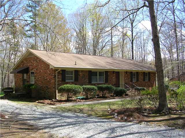 5814 Geoffrey Road Durham, NC 27712 - Photo 19 of 22 a front view of house with yard and green space