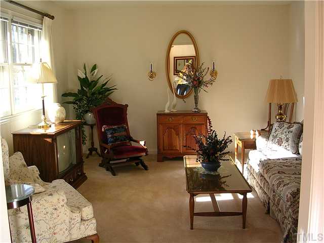 5814 Geoffrey Road Durham, NC 27712 - Photo 3 of 22 a living room with furniture and a potted plant