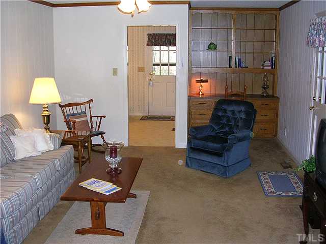5814 Geoffrey Road Durham, NC 27712 - Photo 5 of 22 a living room with furniture and wooden floor