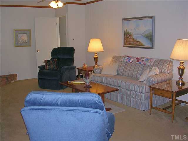 5814 Geoffrey Road Durham, NC 27712 - Photo 6 of 22 a living room with furniture and a lamp