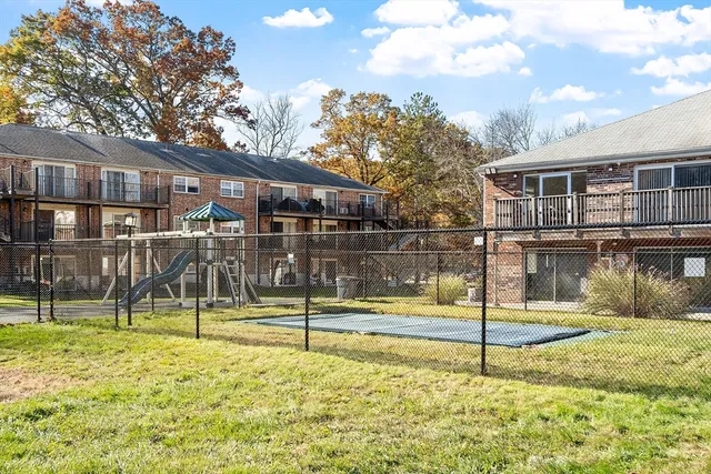 a view of a house with backyard and a tree