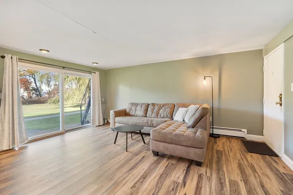 a living room with a couch and next to a window