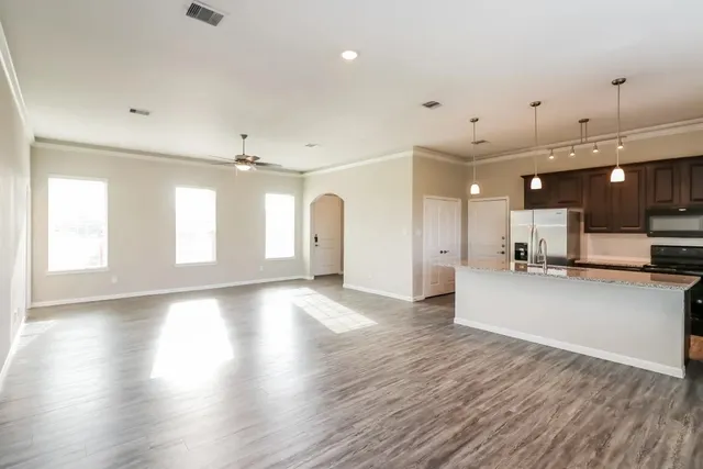 a view of a kitchen and a room with a kitchen