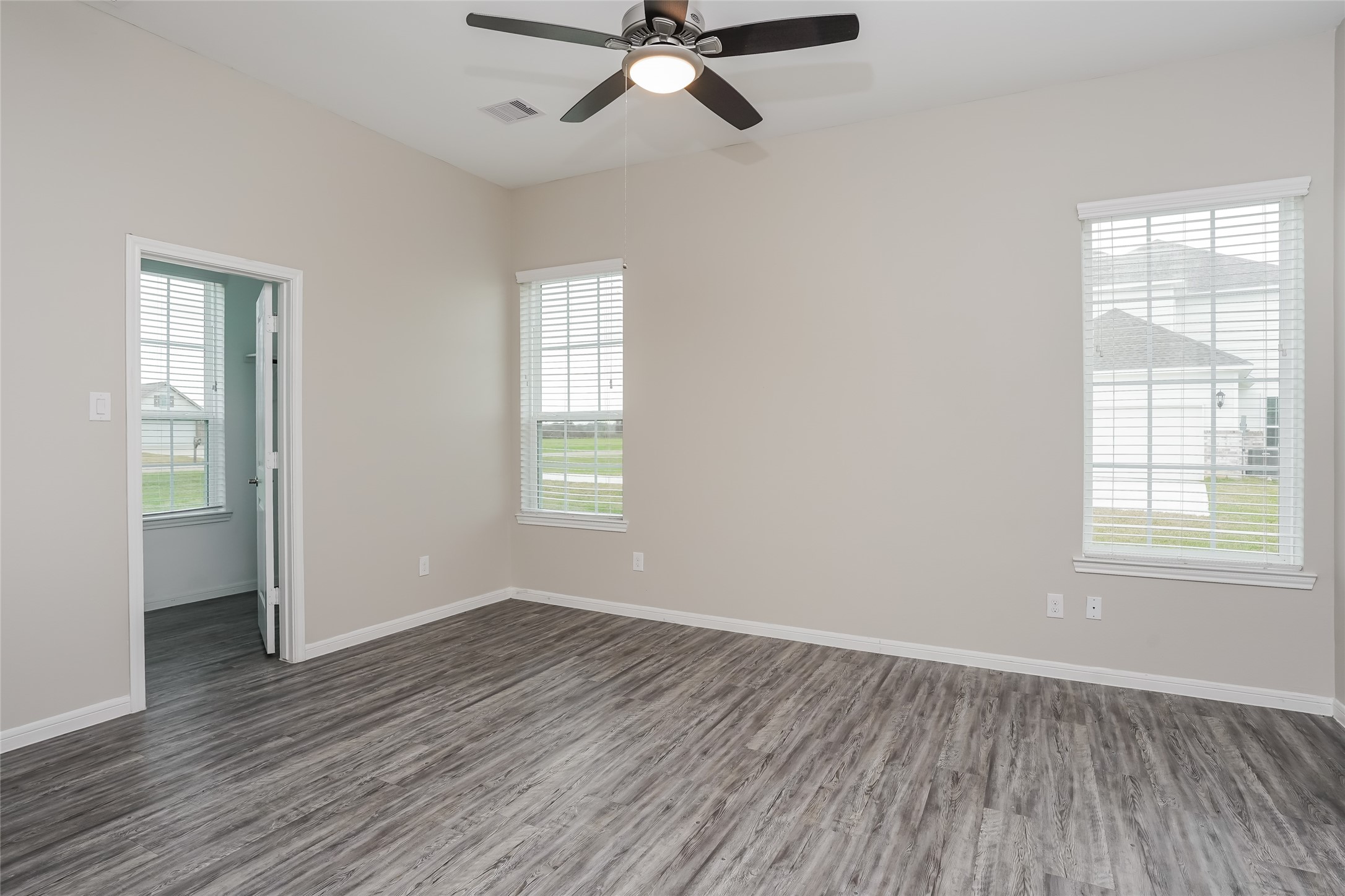 1538 Lakeland Circle Rosharon, TX 77583 - Photo 6 of 12 a view of an empty room with wooden floor and a window