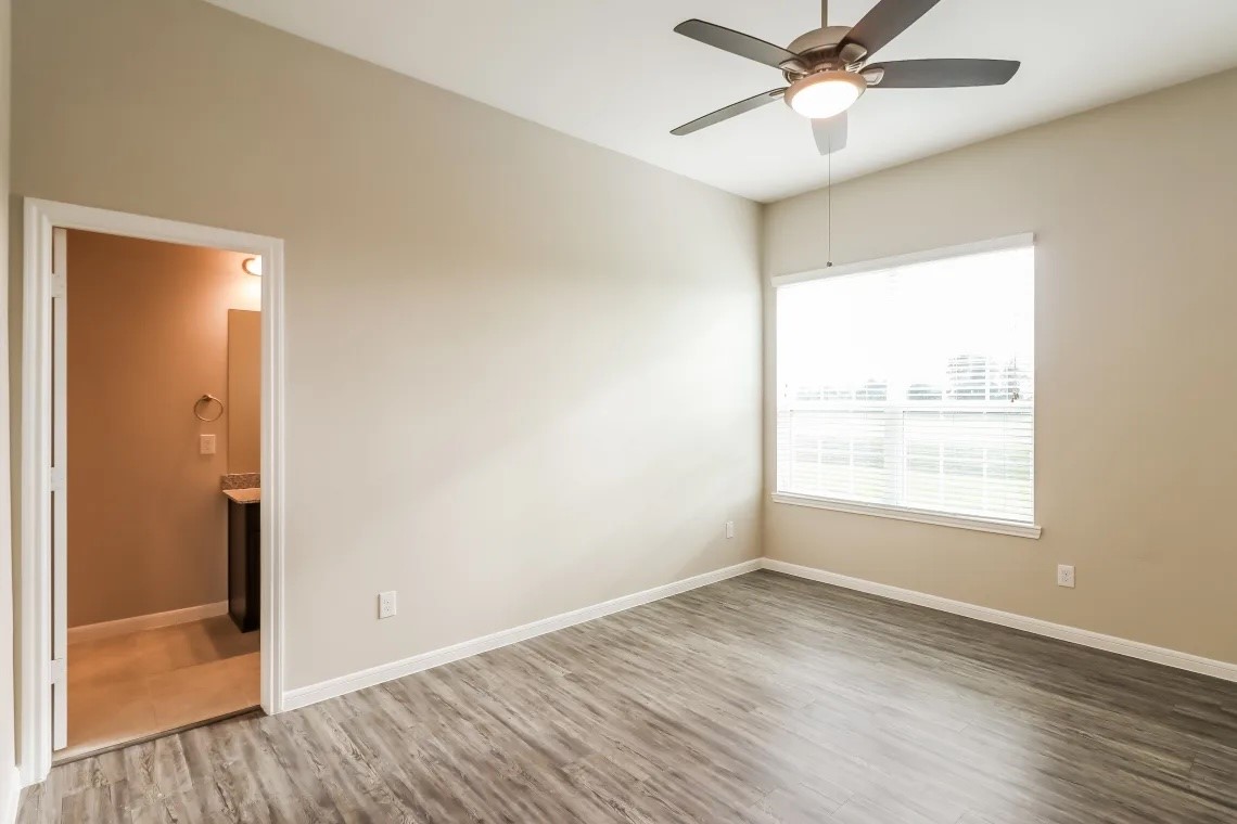 1538 Lakeland Circle Rosharon, TX 77583 - Photo 8 of 12 a view of an empty room with wooden floor and a window