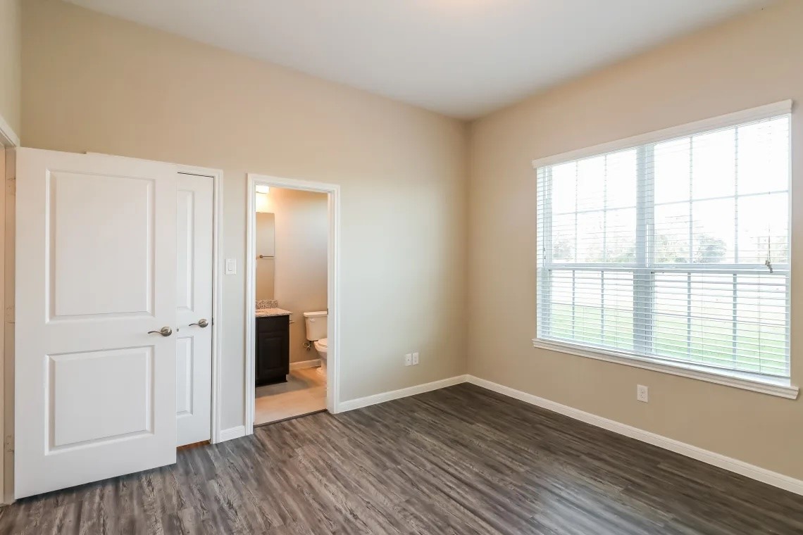 1538 Lakeland Circle Rosharon, TX 77583 - Photo 10 of 12 an empty room with wooden floor and a window