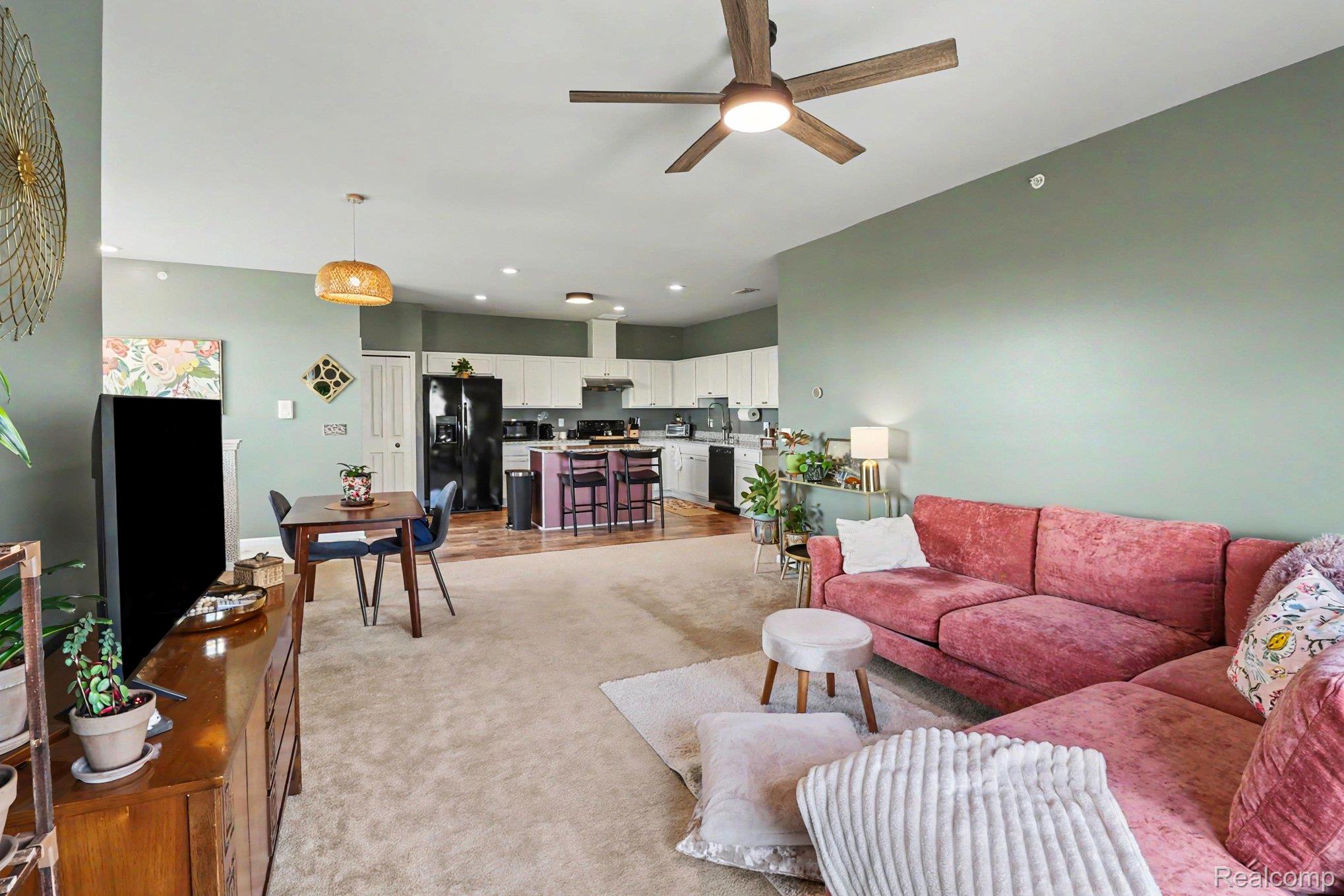 9864 Ridge Run Street Howell, MI 48855 - Photo 7 of 23 Living room with ceiling fan and light carpet