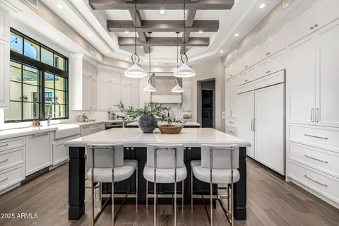 a view of a kitchen area with furniture and wooden floor