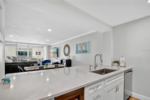 a kitchen with a sink a stove and cabinets