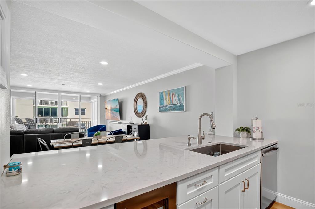 4505 South Atlantic Avenue, Unit 305 Ponce Inlet, FL 32127 - Photo 13 of 34 a kitchen with a sink a stove and cabinets